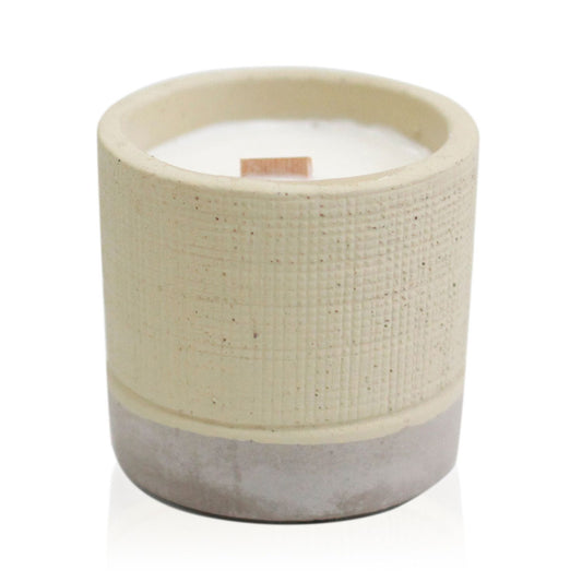 Handcrafted ceramic candle with a textured cream upper body and a grey base