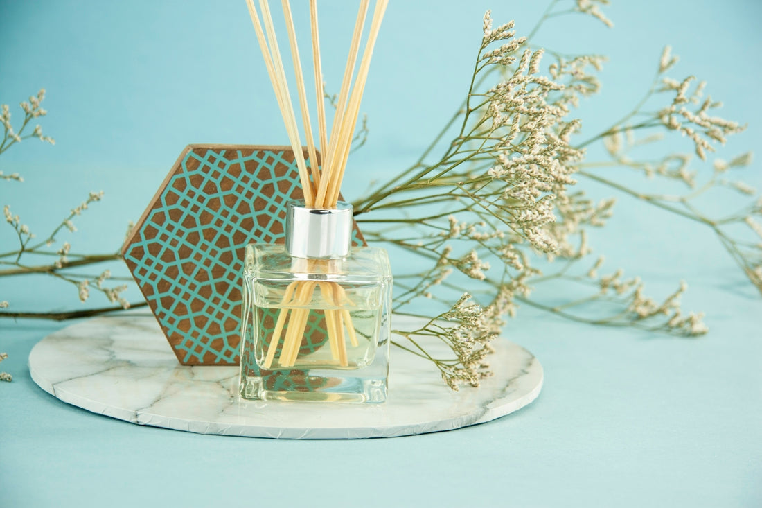 clear glass bottle on white and black floral table cloth