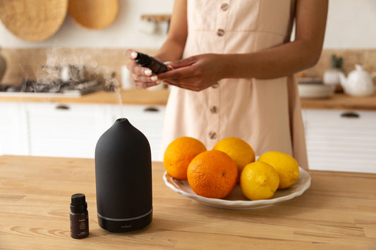 a woman standing in a kitchen next to a plate of fruit