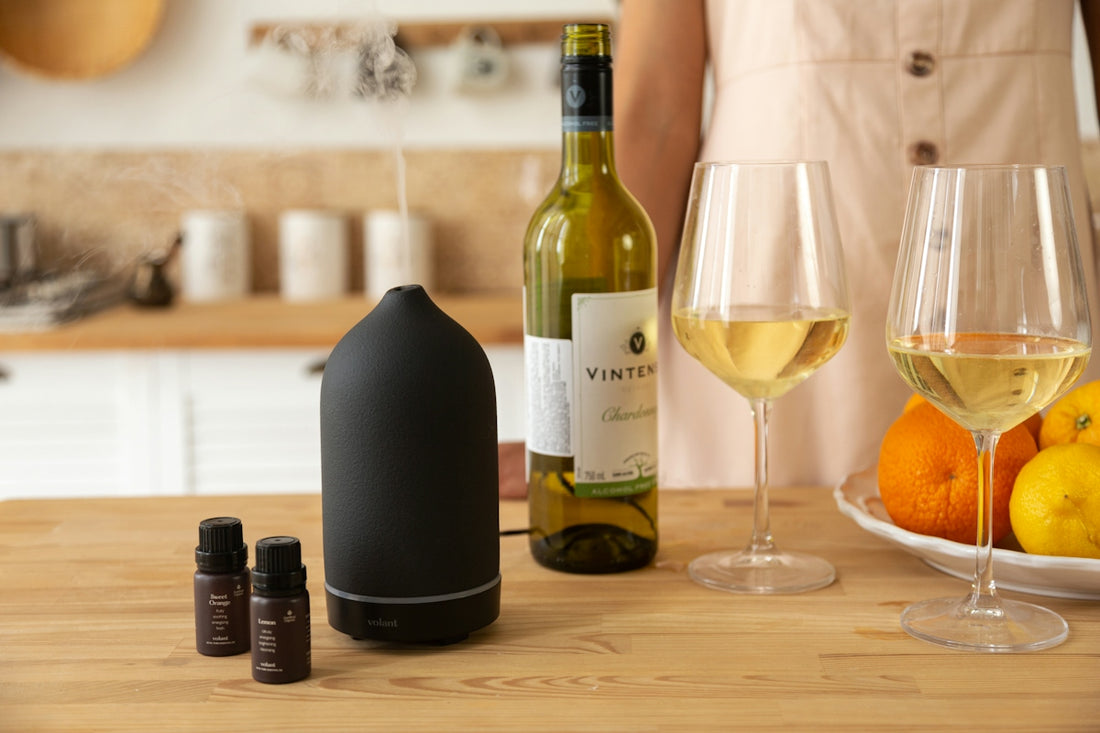 a person standing next to a table with bottles and glasses of wine