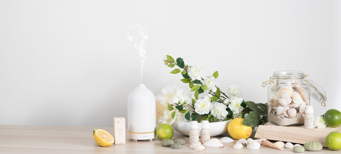 a table topped with vases filled with flowers and lemons