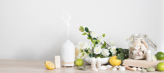a table topped with vases filled with flowers and lemons