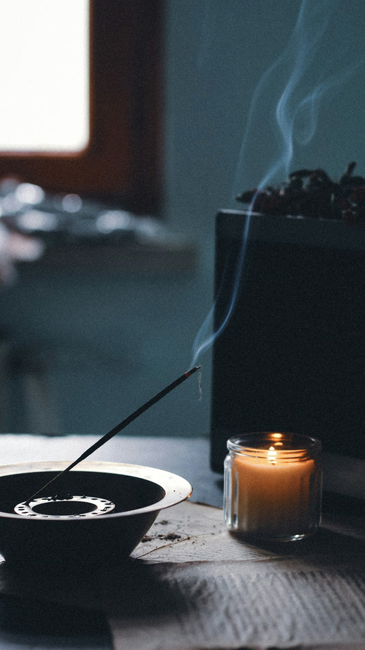 a candle and a bowl on a table