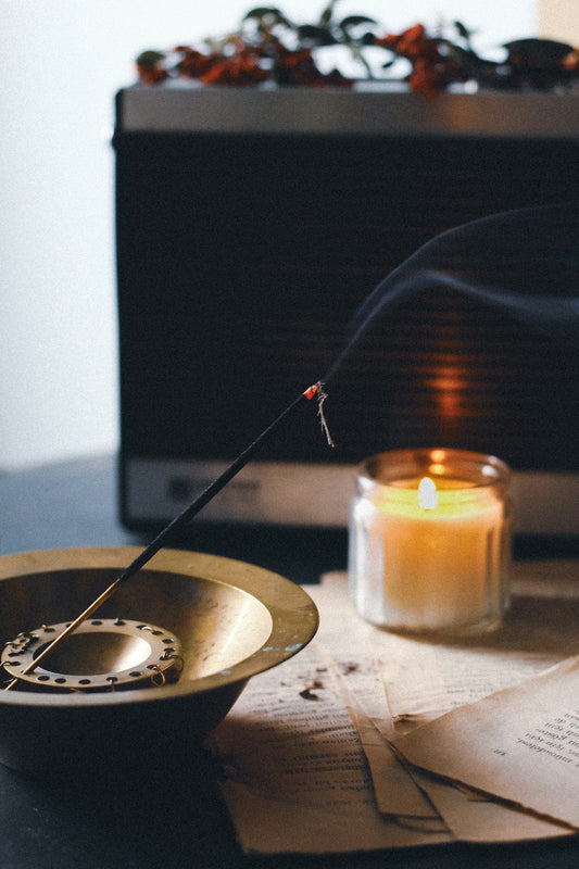 a candle and some papers on a table