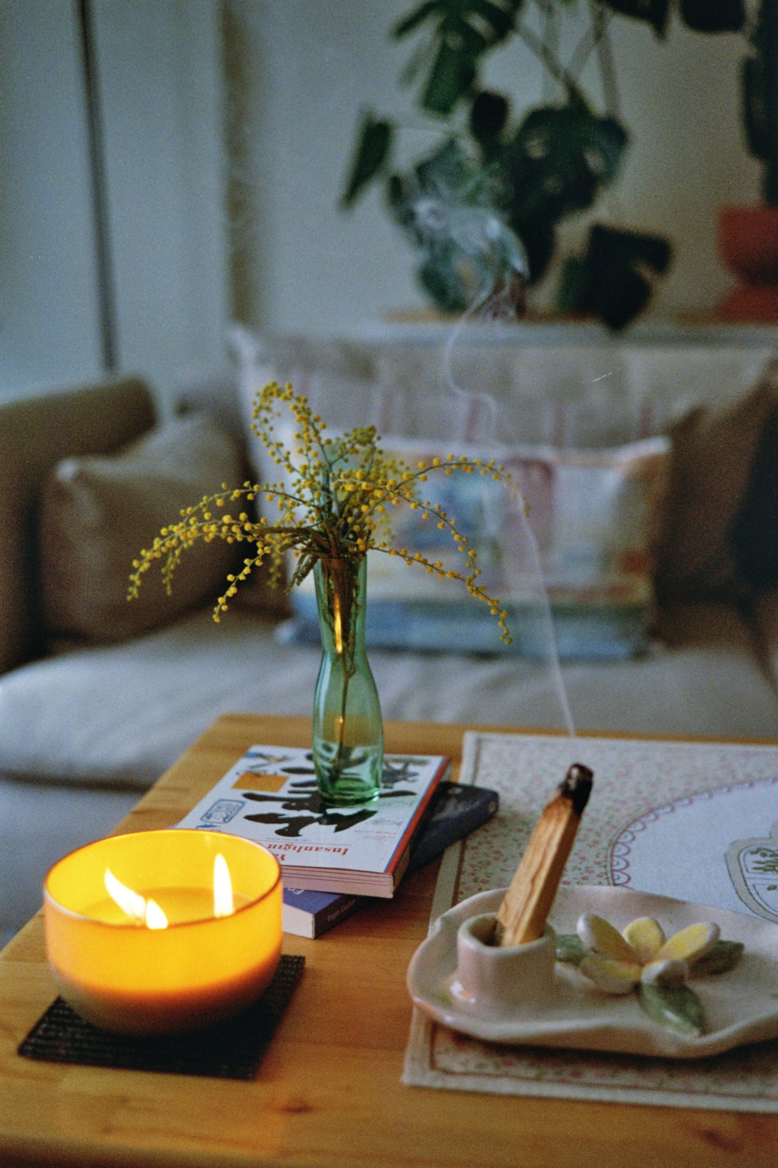 a table with a candle and a book on it