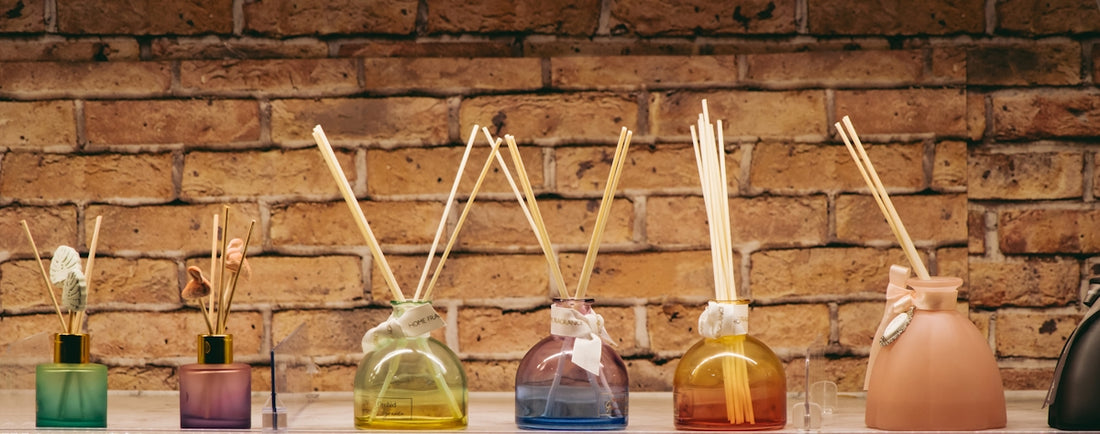A row of bottles with sticks sticking out of them