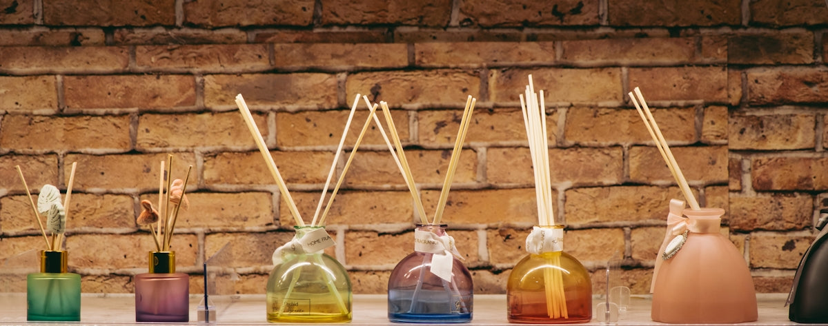 A row of bottles with sticks sticking out of them