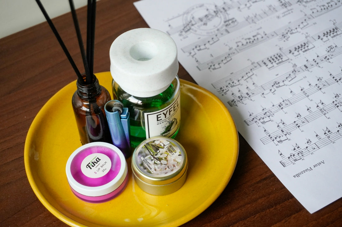 Objects sit on a tray next to sheet music