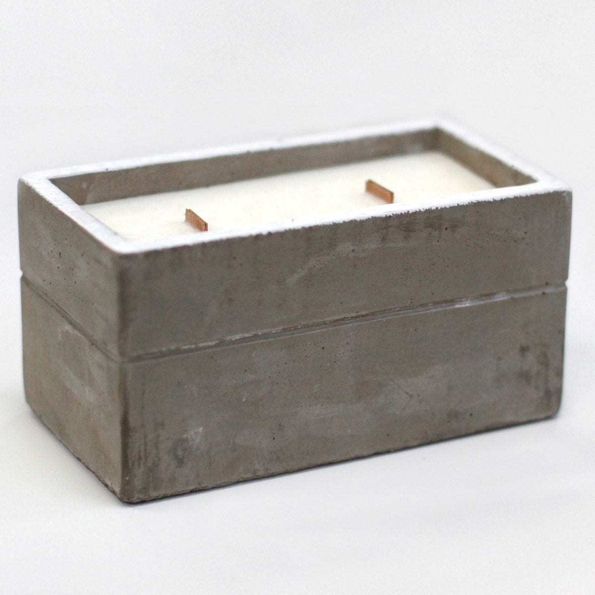 Rectangular grey concrete candle holder with white wax and two wooden wicks