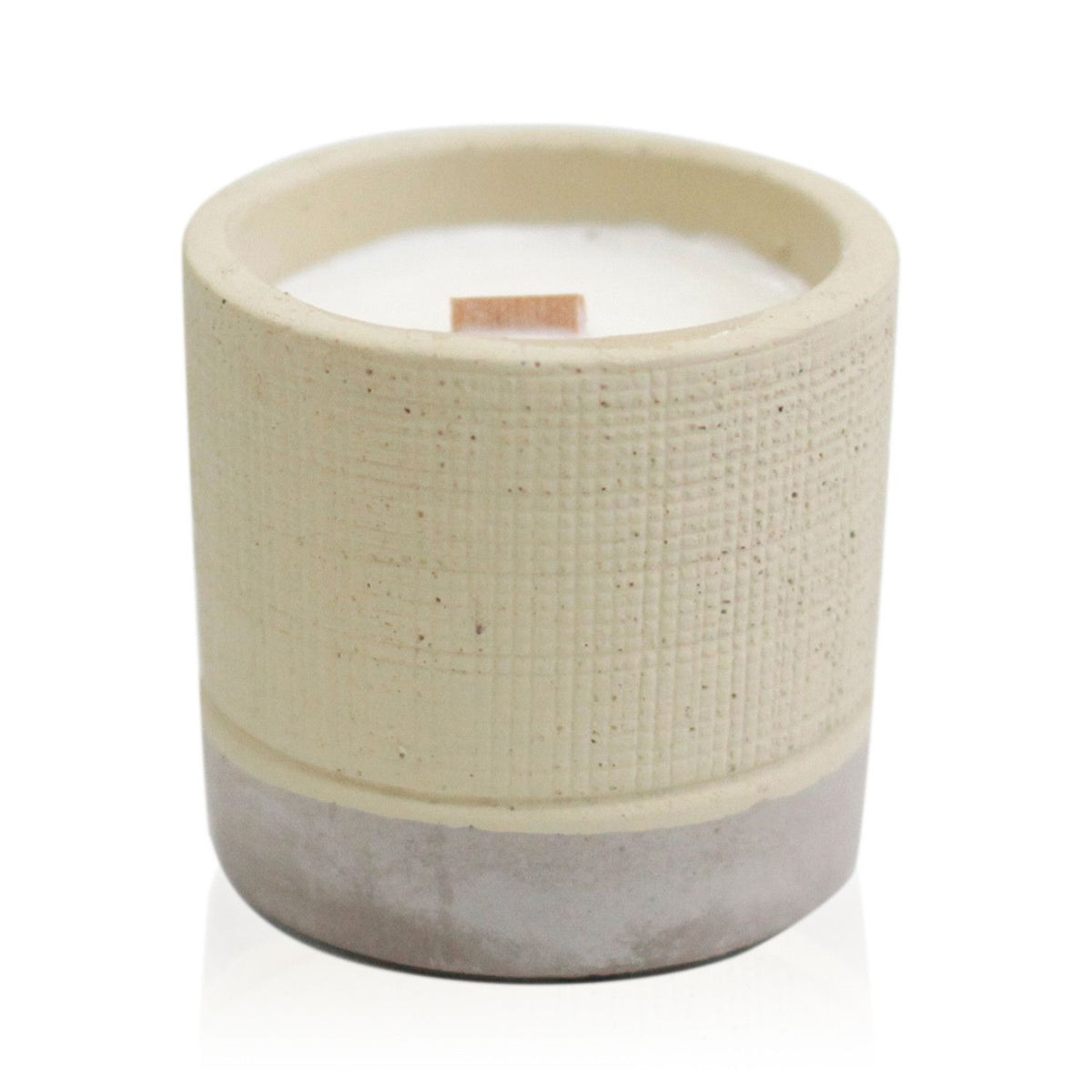 Handcrafted ceramic candle with a textured cream upper body and a grey base