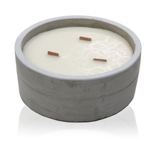 White scented candle with three wooden wicks in a grey concrete container